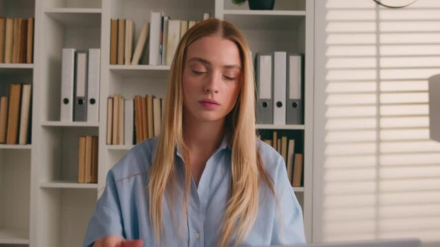 Caucasian girl student woman in library studying writing prep to exam homework feel headache. Businesswoman office laptop working write notes head pain ache painful migraine computer work exhausted