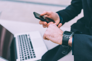 Man using smart phone and smart watch