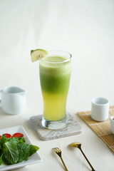 Healthy green smoothie with spinach, banana, lemon, apple and chia seeds in glass jar and ingredients. Detox, diet, healthy, vegetarian food concept with copy space.