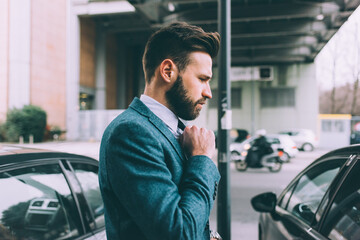 Business man adjusting tie