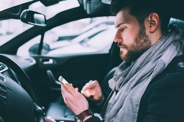 young bearded businessman driving car