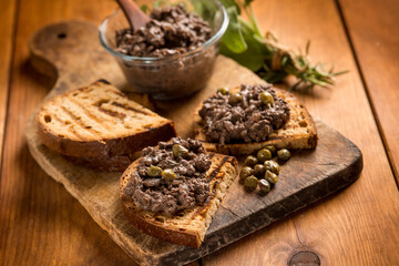 italian canape with liver pate over wood table