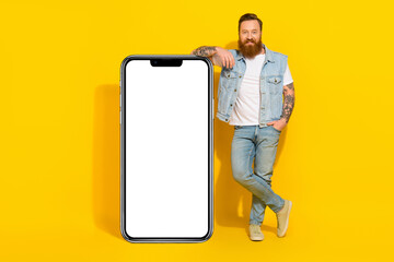 Photo of pretty cool guy dressed denim vest modern gadget empty space isolated yellow color background