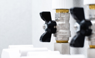 two black ball valves in the plumbing system designed to open and close the water supply