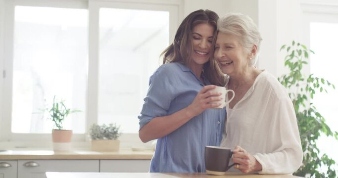 Relax, woman and senior mother with coffee, talking and chatting in the kitchen, bonding and happiness. Adult female, daughter and mama at home, conversation and loving with tea, discussion and joy
