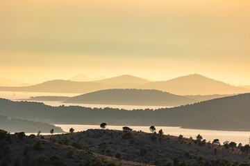 Mesmerizing view of evergreen mountains surrounding the sea during a scenic sunset in Croatia