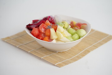 Es buah or sop buah-is an Indonesian iced fruit cocktail dessert, on white background