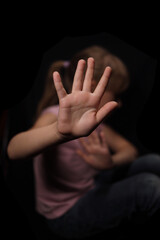 Little girl shows hand stop sign, concept of protection from domestic violence children