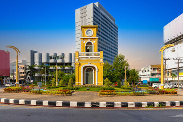 Clock tower on a roundabout in old phuket town at during the summer day surrounded by high-rise...