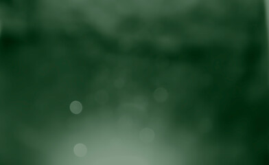 Abstract soft green blurred bokeh glitter on shiny light backdrop smooth background.