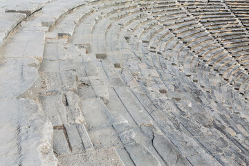Ruins of old theater in Side, Turkey (Turkiye). Close up fragment of marple spectators seats