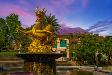 Fototapeta premium Golden dragon in old phuket town phuket Thailand this dragon is on the middle of a big water pond and fountain Chinese Dragon