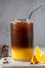 Bumble coffee mix with orange juice and cold brew coffee with ice. Summer trendy refreshing coffee drink.