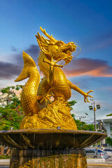 Golden dragon in old phuket town phuket Thailand this dragon is on the middle of a big water pond...