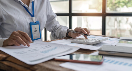 Businesswoman or accountant working Financial investment on calculator, calculate, analyze business and marketing growth on financial document data graph, Accounting, commercial concept