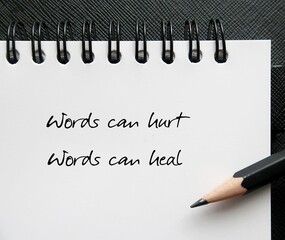 Notebook with handwritten text Words can hurt Words can heal - to remind language have power to...