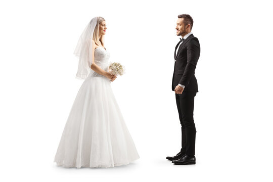 Full length profile shot of a bride looking at a groom
