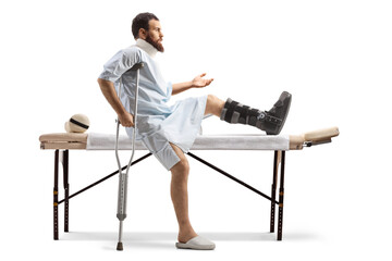Patient with a leg injury sitting on a bed for physical therapy