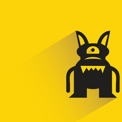 alien monster with shadow on yellow background