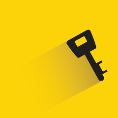 door key with shadow on yellow background