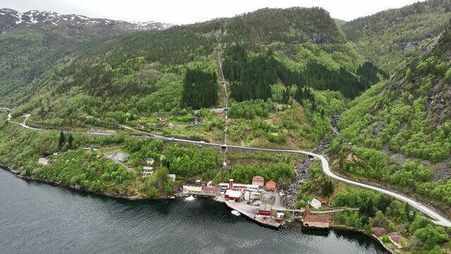 Water pipes coming down hillside to small hydroelectric powerplant in Vadheim Sogn Og Fjordane Norway - Aerial