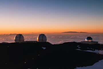 Beautiful shot of the Mauna Kea Observatories on a seaside at sunset