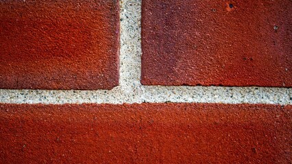 Closeup of  white grout on red brick wall