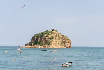 Beautiful view of a rocky cliffs in the water with boats around in Bangchui island, China