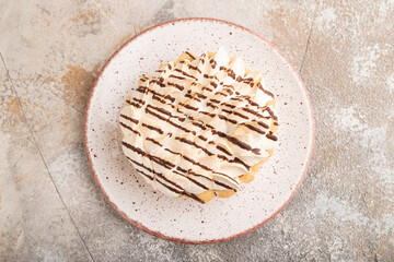 Two tartlets with meringue cream on brown concrete,  top view.