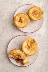 Traditional portuguese cakes pasteis de nata, custard small pies on gray concrete. Top view, close up.