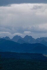 Layers of a mountain range in shades of blue, vertical