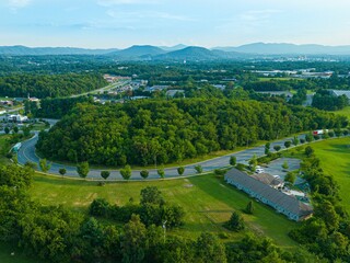 Aerial shot of a highway amid the green forests and valleys in Roanoke, VA, USA