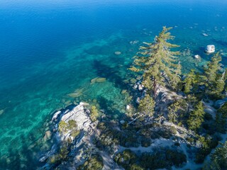 Aerial view of the lake Tahoe with trees on a sunny day in the Sierra Nevada of the United States