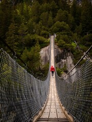Beautiful shot of a wooden long footbridge above the deep gorge in Switzerland