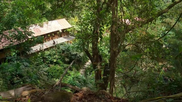 Marinka waterfalls in Minca, Santa Marta Colombia. Nature tourist attraction. A place where people enjoy the refreshing cold water while swimming and bathing below the waterfall in the river.