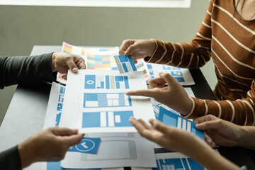  A team of web designers are working together to develop a mobile-responsive website with UI/UX...