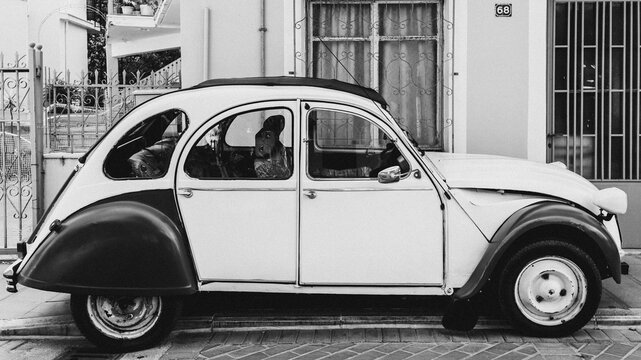 Old vintage Citroen 2cv6 car parked on the city roadside