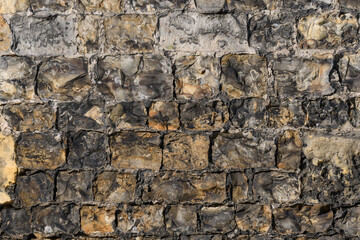 Stone laying of the wall of an ancient castle. Texture