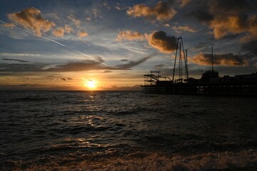 Naklejka na ściany i meble Beautiful shot of a pier in the sea at sunset