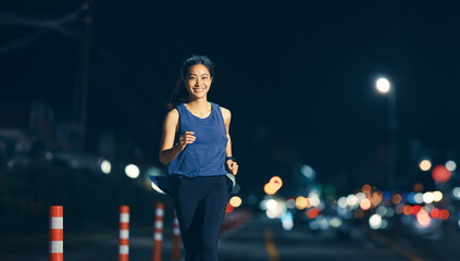 Asian woman practicing running at night