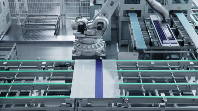 Time-lapse video of Automated Solar Panel Production Line. Industrial Robot Arms Assemble Solar Panel, Placing PV Cells. Modern, Bright Manufacturing Facility. Loopable video.