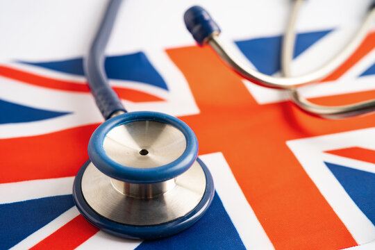 Stethoscope on United Stethoscope on United Kingdom flag background, Business and finance concept.Kingdom,flag background, Business and finance concept.