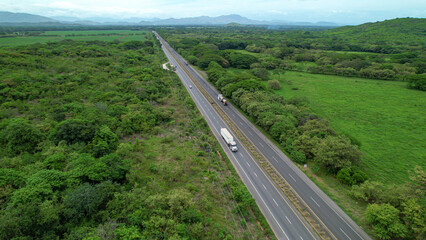 AERIAL Pan-American Highway stretching along scenic tropical landscape of Panama - obrazy, fototapety, plakaty