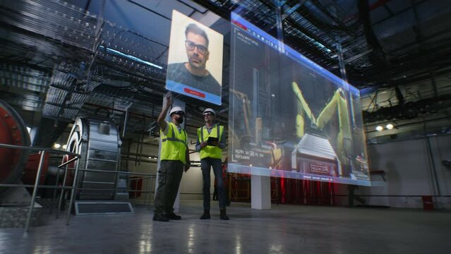 Two male workers in VR headsets at factory have video conference with coworker using virtual 3D hologram. 3D render of video call and industrial equipment. Modern, digital communication technologies.