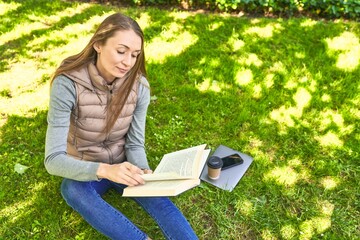 Lost in a world of words, a woman finds serenity in parkside reading.