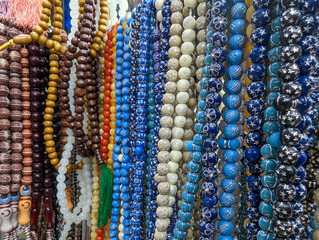 Plastic rosary market view. Colorful plastic rosaries close up shot in the market. Religious beads...