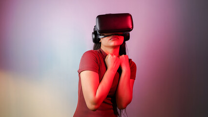 Young Asian Indian woman scared, wearing virtual reality headset, a frightened girl with VR glasses...