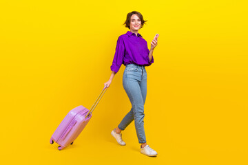 Full size photo of pretty young girl go gadget taxi application wear trendy violet smart casual outfit isolated on yellow color background