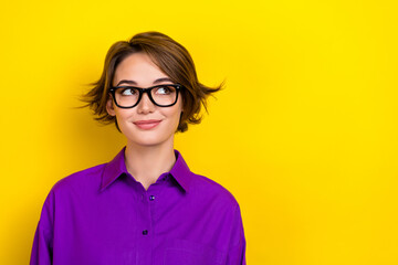 Photo portrait of attractive lady wondering look empty space wear eyeglasses violet blouse isolated yellow color background