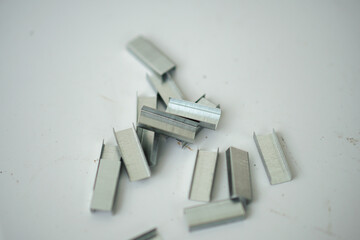 Metal staples for stapler isolated on white background - obrazy, fototapety, plakaty